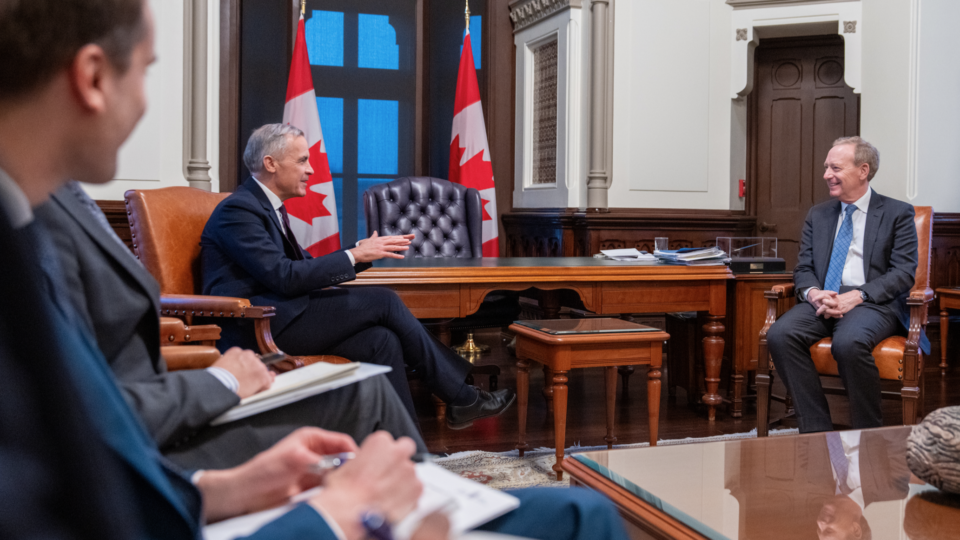Brad Smith sitting with the Prime Minister in Ottawa.